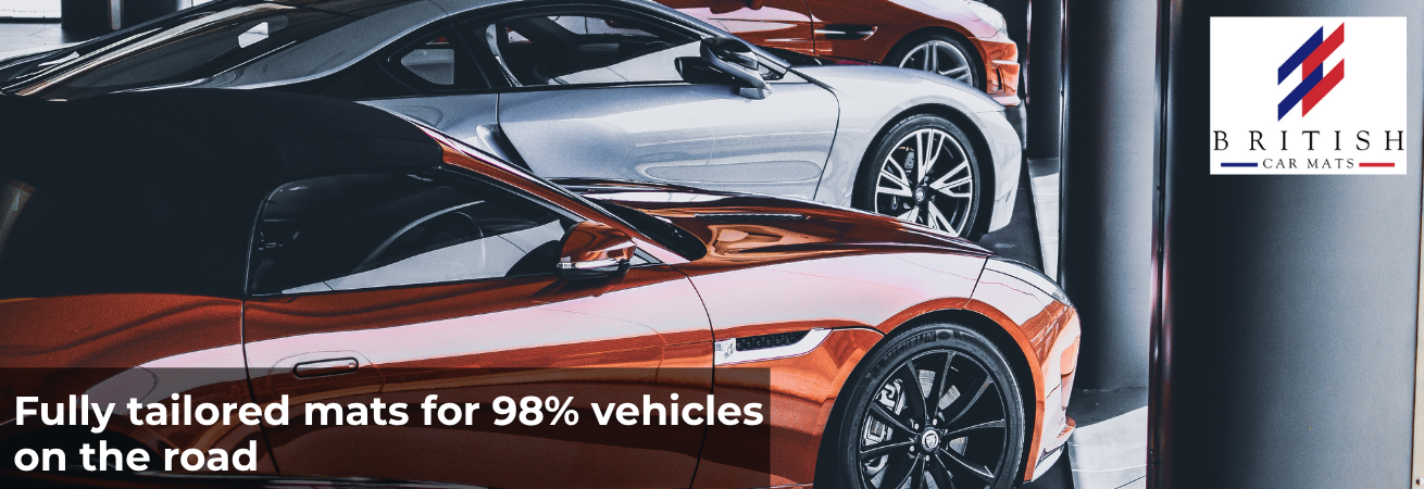 A promotional image for British Car Mats. The background shows a row of high-end sports cars parked inside a stylish, modern showroom. In the top right corner, there is the logo of British Car Mats featuring three bold diagonal stripes in red and blue. The main text on the image reads: “Fully tailored mats for 98% of cars on the road.” Below this, it says: • Manufactured in the UK with latest technology and software • 100% accurate fitting